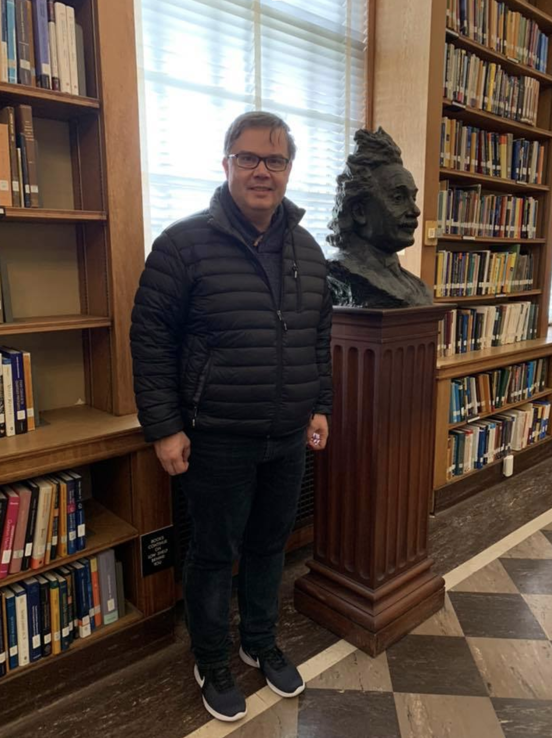 Gregory Renard beside the bust of Albert Einstein