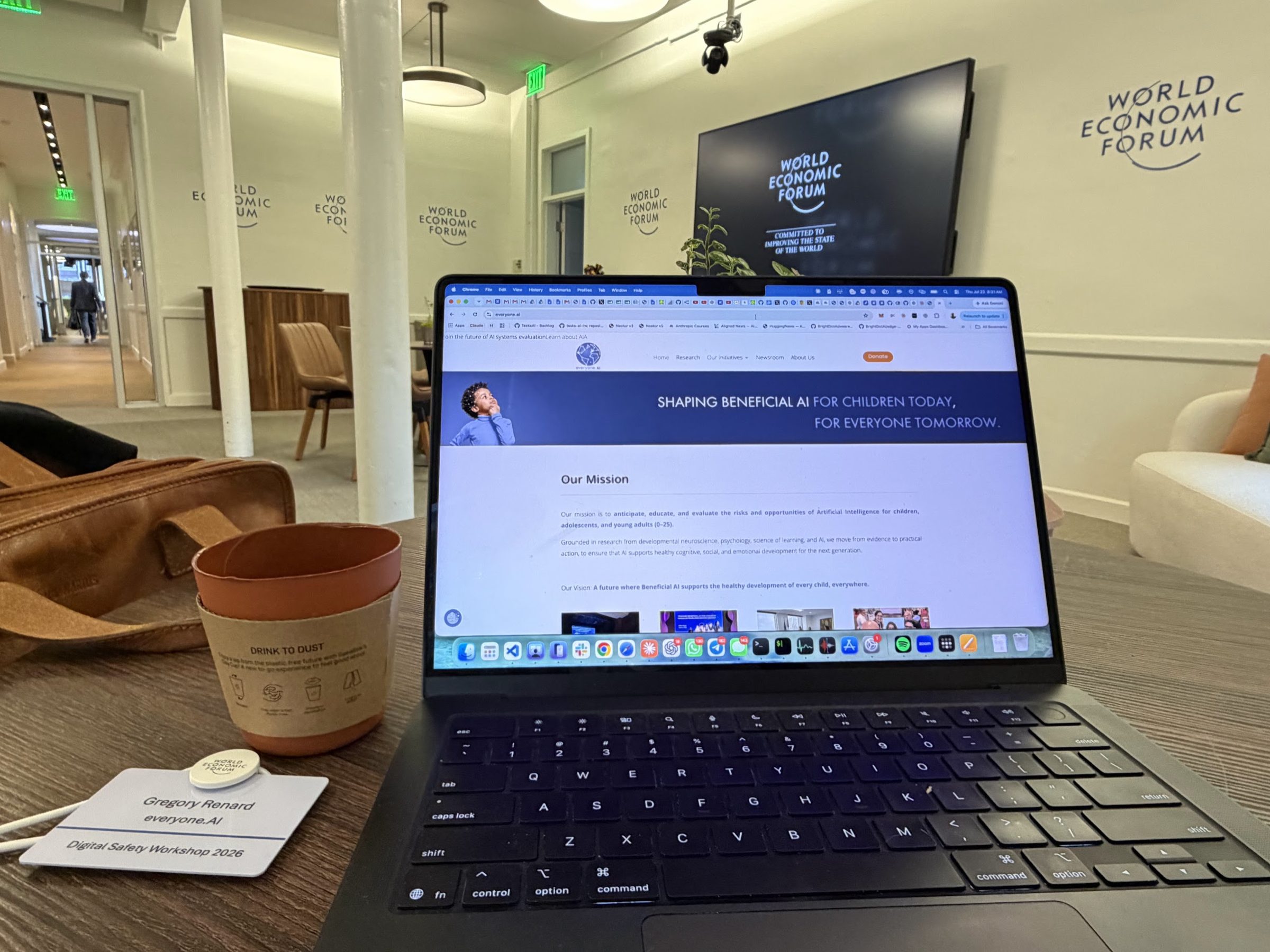 Everyone.AI mission page on a laptop at the World Economic Forum office